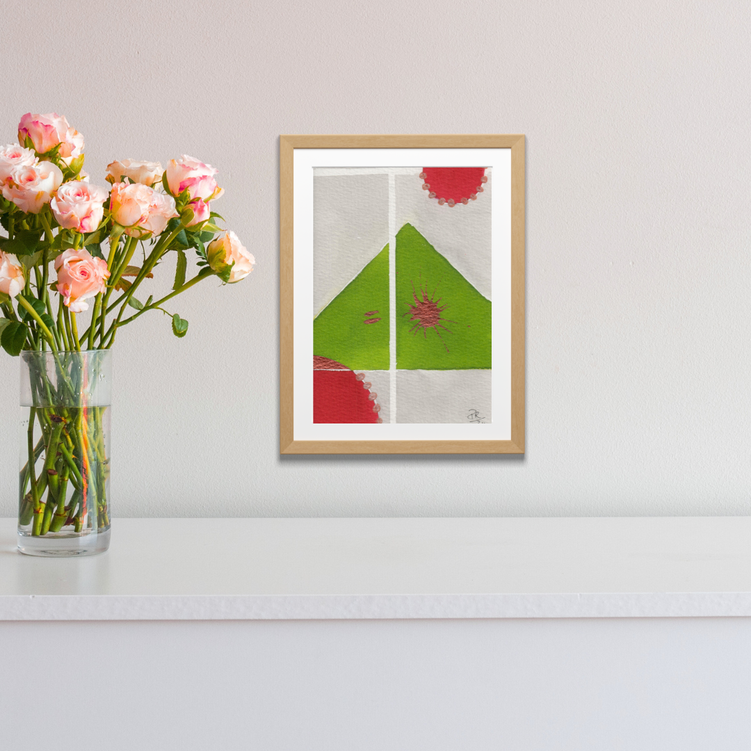 Framed abstract art piece on a wall with a vase of flowers next to it.