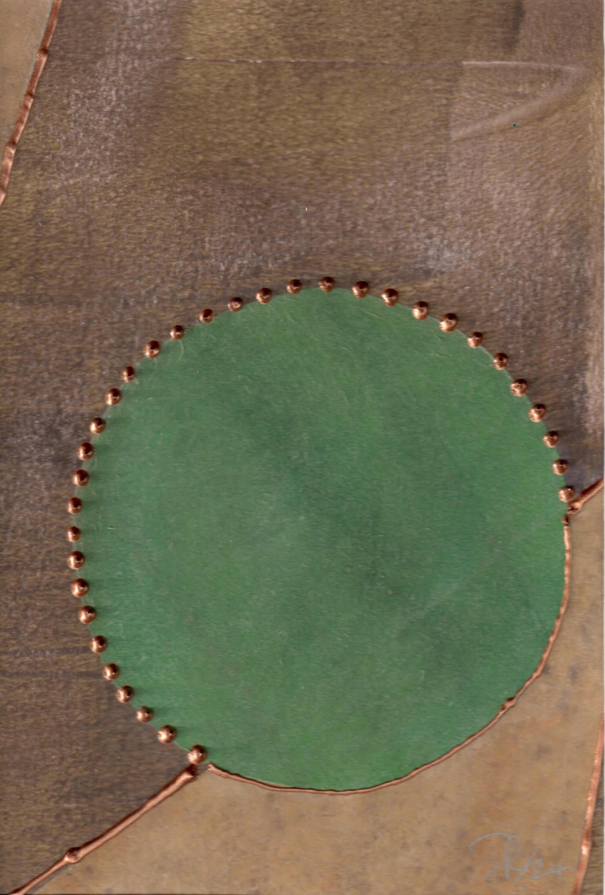 Green circle with copper border on textured brown background