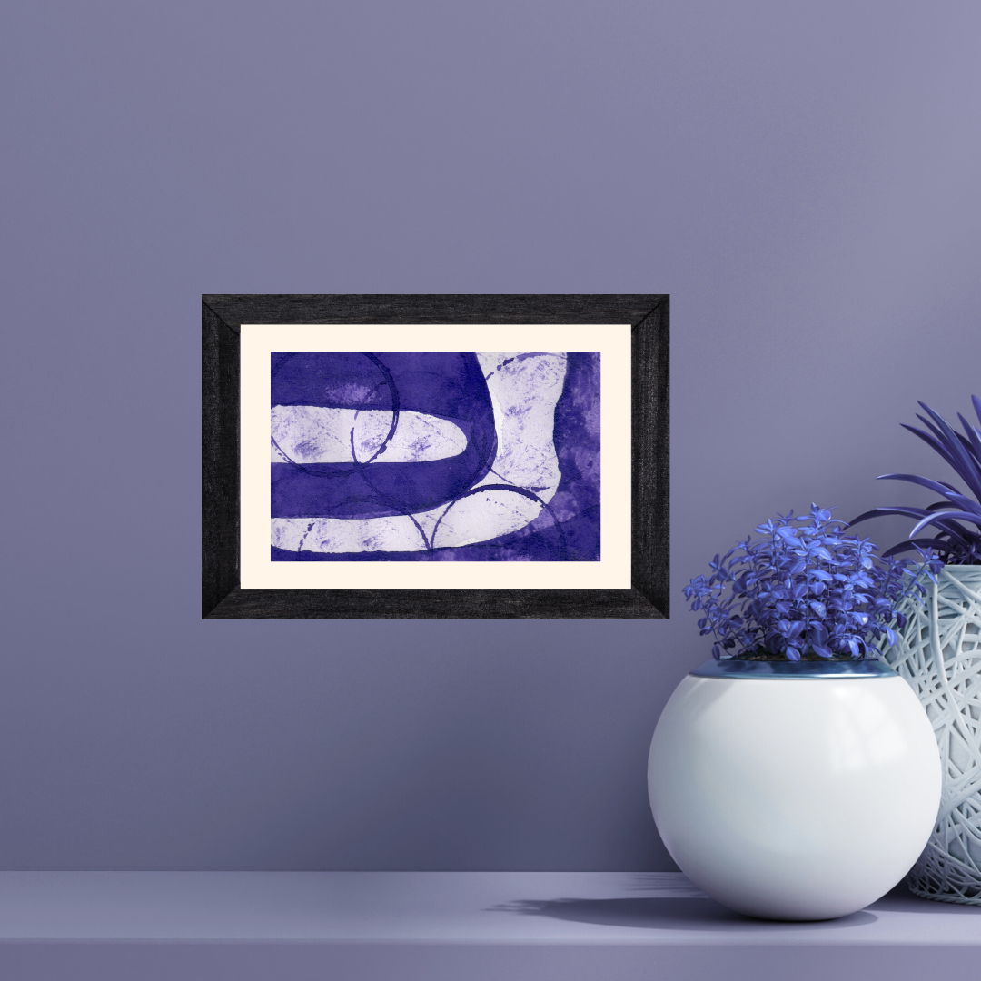 Framed abstract art piece on a purple wall with decorative plants.