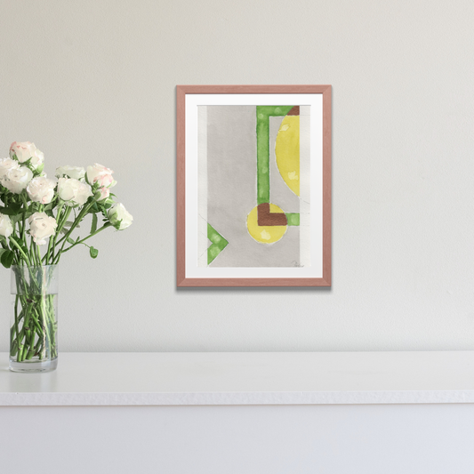 Framed artwork with a geometric design on a wall next to a vase of flowers.