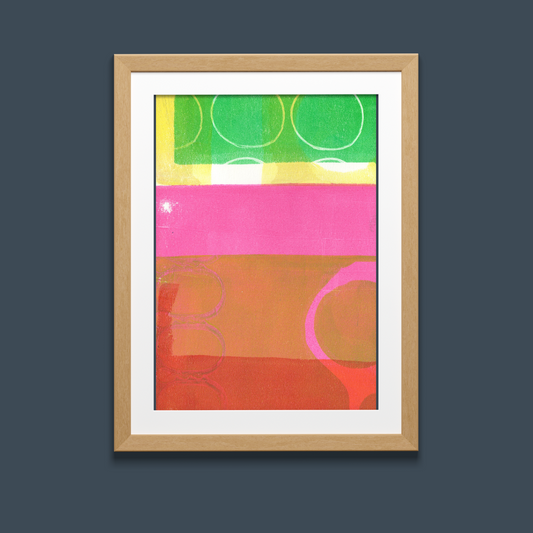 Framed abstract art print with colorful geometric shapes on a dark background