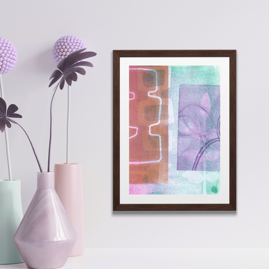 Framed abstract art piece on a wall with decorative vases and plants.