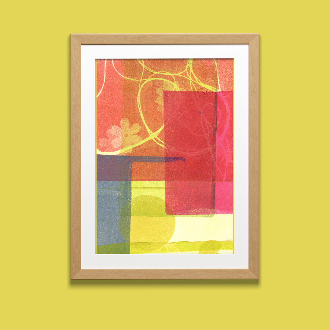 Framed abstract artwork with colorful geometric design on a yellow wall