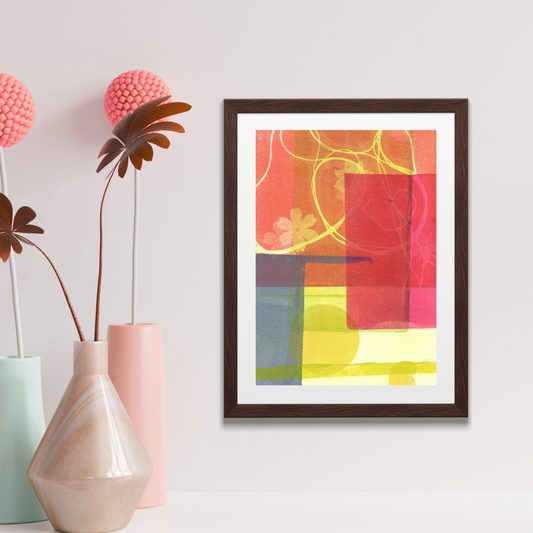 Framed abstract art on a wall with decorative vases and plants.