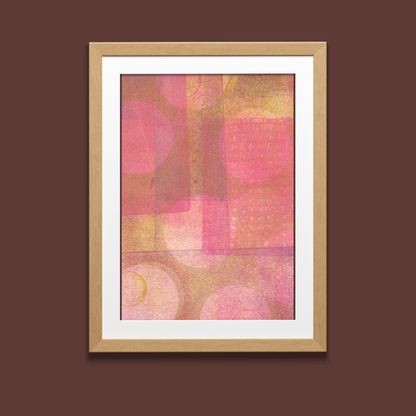 Framed abstract art print with pink and brown colors on a brown background