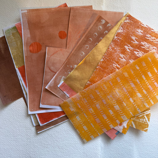 Collection of patterned paper sheets in various colors on a white surface