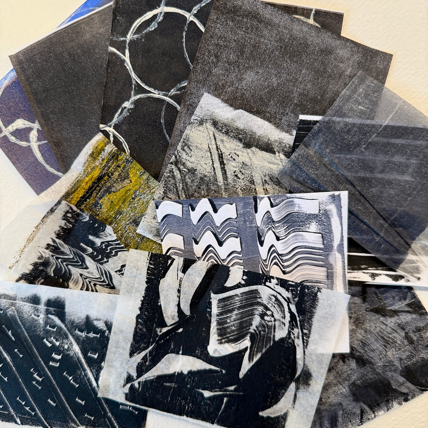 Collage of various black and white abstract collage paper pieces.