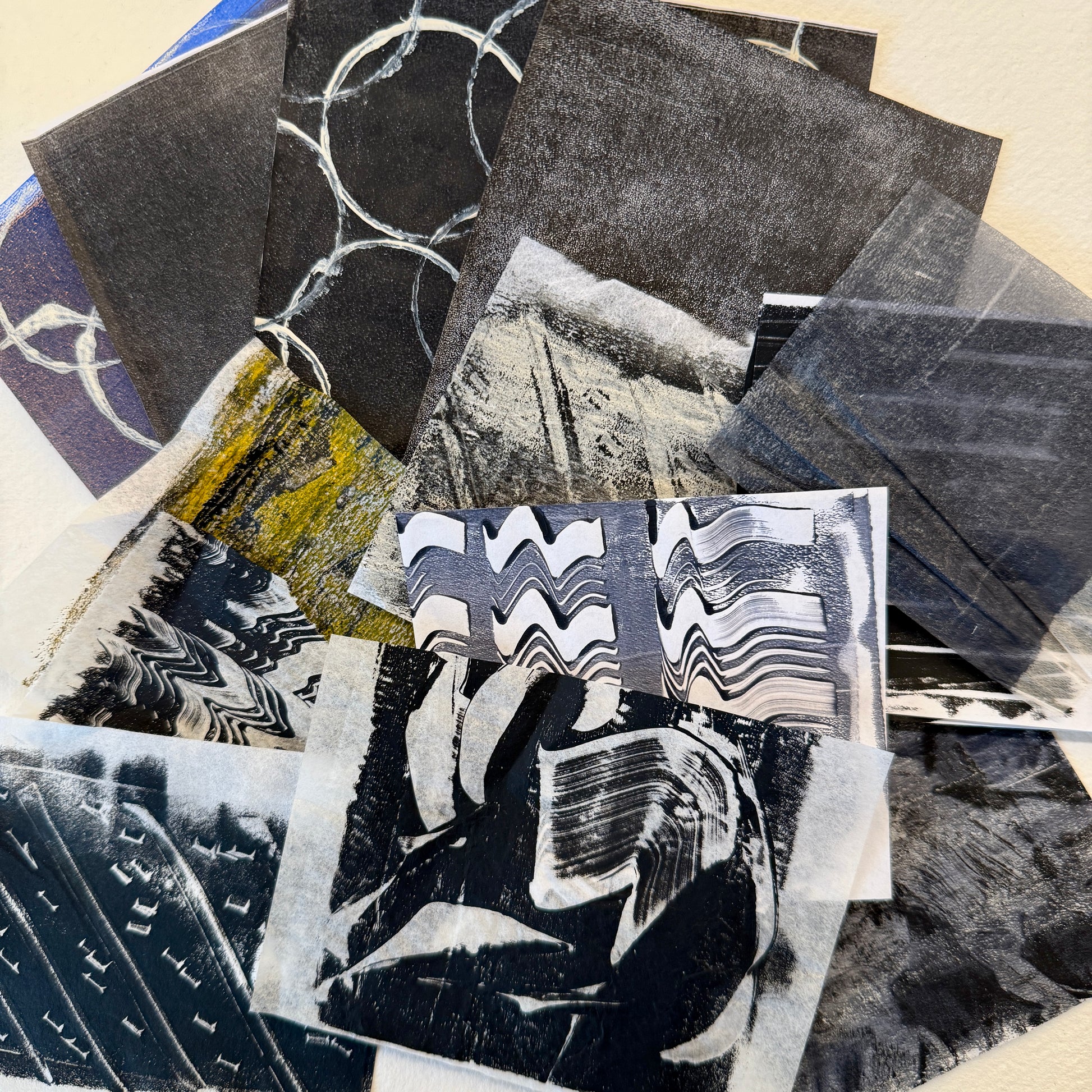 Collage of various black and white abstract collage paper pieces.