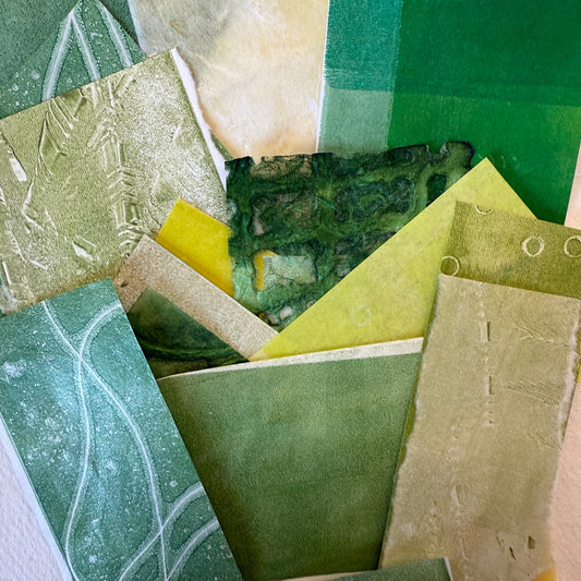 Collection of green textured paper samples on a white background
