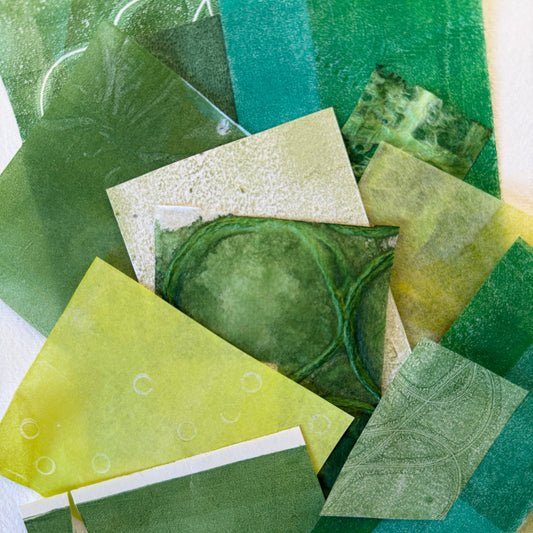 Collection of green textured paper samples on a white background